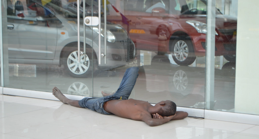homeless person looking at cars